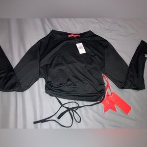 Cute long sleeve belly shirt with open back that ties with a string.